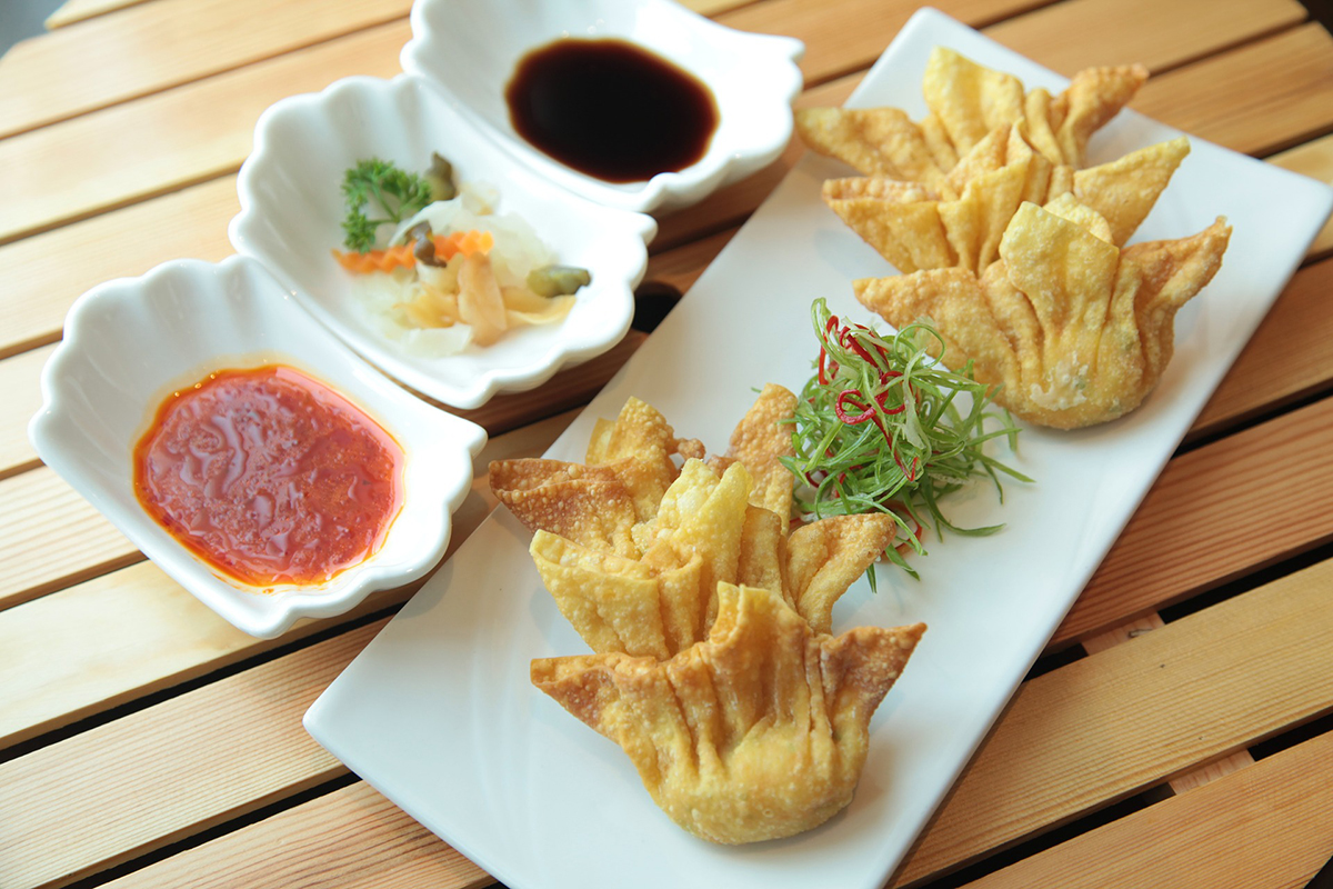 Crispy fried wontons served with assorted dipping sauces and fresh garnish