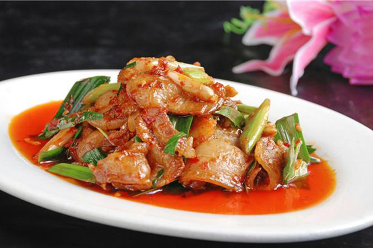 Sliced pork stir-fried with green onions in a spicy red chili sauce