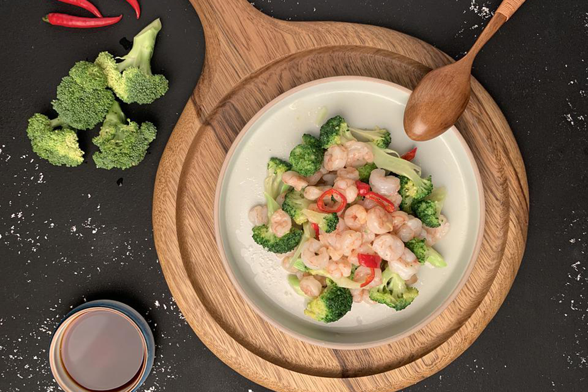 Stir-fried shrimp with broccoli and red peppers served in a bowl